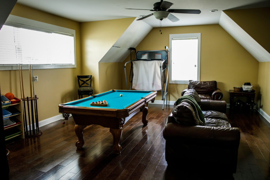 pool table in man cave with hardwood floor