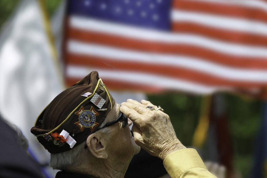 veteran saluting flag on memorial day