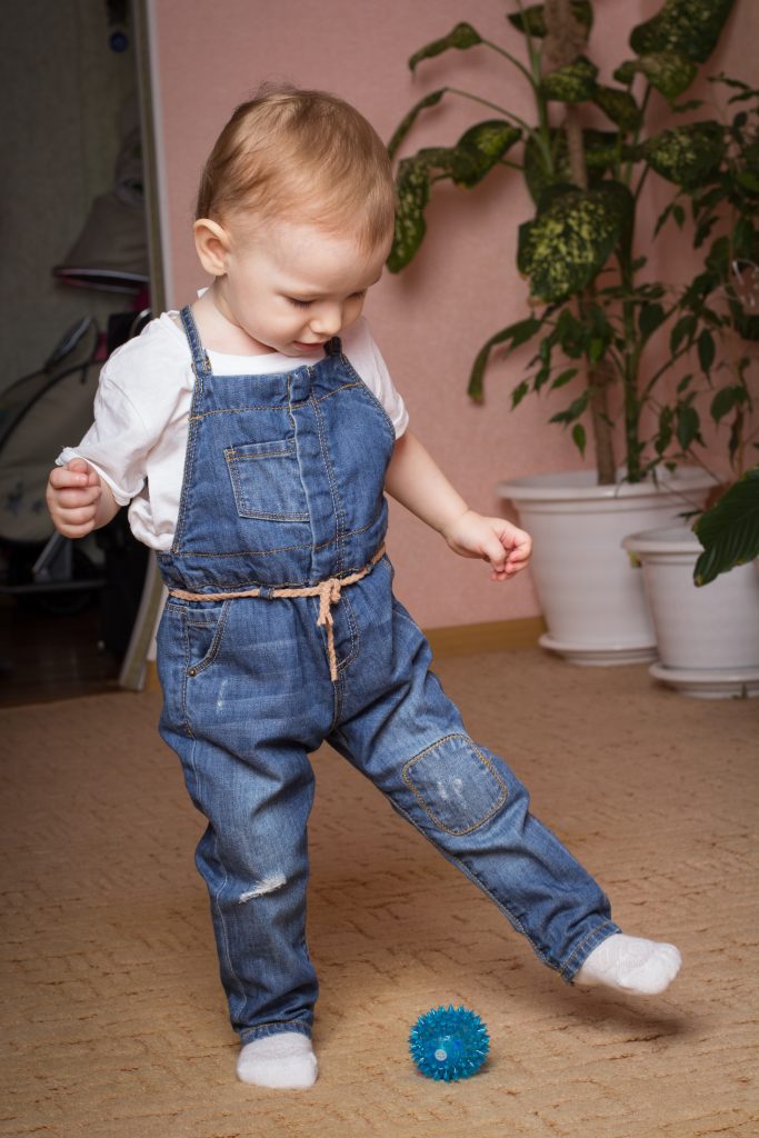 little girl kicking ball on mohawk exquisite touch smartstrand carpet in clay trail